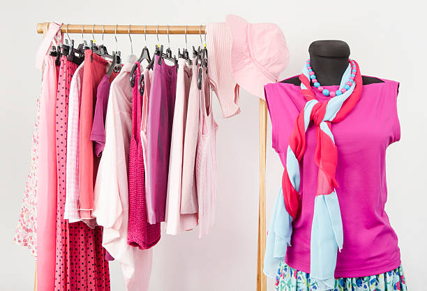 Pink clothing and accessories displayed on a rack and mannequin, highlighting summer wardrobe options for over 50s.